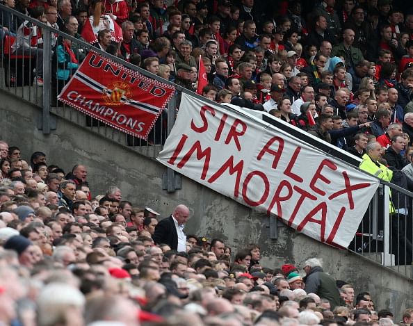 Immortal: Old Trafford was filled with banners such as this one and fans were given 'Champions 20 | 13' flags by the club on what was a emotional day at Old Trafford. (Getty Images)